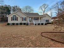 Charming single-story home featuring a cozy front porch and well-manicured landscaping at 21 Fortson Dr, Hampton, GA 30228