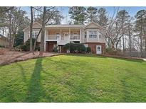 Charming two-story home with a covered front porch and a well-manicured lawn at 3114 Superior Dr, Dacula, GA 30019