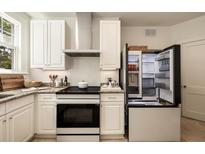 Well-equipped kitchen with white cabinets, granite counters, and stainless steel appliances at 435 10Th Ne St # 18, Atlanta, GA 30309