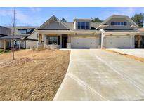 Charming home featuring a two-car garage and a manicured front lawn at 272 Laurel Canyon Pkwy, Canton, GA 30114