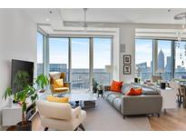 Modern living room with floor-to-ceiling windows and amazing city views at 1080 Peachtree Ne St # 3507, Atlanta, GA 30309