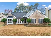 Charming brick home featuring a manicured front yard and inviting curb appeal at 3130 Goldmist Dr, Buford, GA 30519