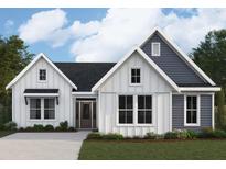 Charming two-story home featuring a mix of white and gray siding, complemented by large windows and a well-manicured lawn at 125 Laurel Farms Ln, Dallas, GA 30157