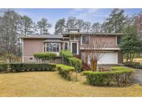 Charming home featuring manicured landscaping, a two-car garage, and a welcoming front entrance at 2010 Barnes Mill Rd, Marietta, GA 30062