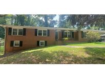 Charming brick home with well-maintained front yard and decorative iron porch columns at 3879 Artist Vw, Decatur, GA 30034