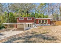 Charming mid-century home with a carport and professionally landscaped front yard at 3398 Lori Ln, Atlanta, GA 30340