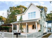 Charming two-story home featuring white siding, a covered front porch, and a well-manicured front yard at 185 Marion # A, Atlanta, GA 30307
