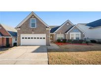 Charming brick home with a two-car garage and well-maintained lawn at 1461 Beckley Pointe, Lawrenceville, GA 30043