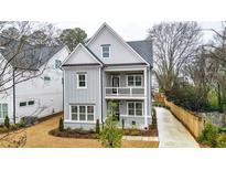 Charming two-story home featuring a double front porch and well-manicured front yard at 1593 Roswell Se St, Smyrna, GA 30080