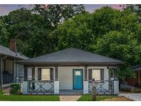 Charming home featuring a blue front door and inviting front porch with decorative railing at 872 Beryl Sw St, Atlanta, GA 30310