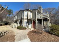 Two-story condo features a covered balcony, private entrance, and a well-manicured yard at 1401 Riverview Se Dr # 1401, Marietta, GA 30067