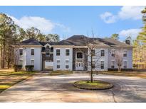 Stately home featuring a circular driveway, a three-car garage, and an elegant stone-accented facade at 9610 Cedar Grove Rd, Fairburn, GA 30213