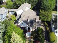 Charming home with lush landscaping, brick chimney, and detached garage at 1666 Johnson Ne Rd, Atlanta, GA 30306