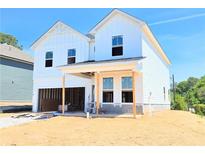 Two-story new construction featuring white siding, and an attached garage with covered parking at 650 Redhead Way (Lot 25), Grayson, GA 30017