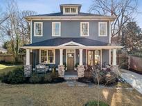 Charming two-story home with a welcoming front porch and well-manicured landscaping at 100 Daniel Se Ave, Atlanta, GA 30317