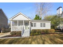 Charming home featuring a covered front porch, well-maintained landscaping, and a classic design at 2796 Georgian W Dr, Brookhaven, GA 30341