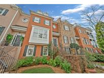 Elegant brick townhomes with well-manicured landscaping and charming architectural details at 2602 Brookhaven Chase Ne Ln, Brookhaven, GA 30319