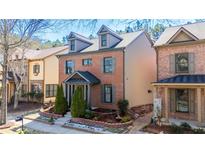 Charming brick home featuring a cozy front porch and well-manicured landscaping at 3780 Baxley Pine Trl, Suwanee, GA 30024