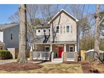 Charming two-story home with a inviting front porch and a bright red front door at 1892 Braeburn Se Cir, Atlanta, GA 30316