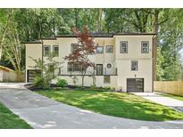 Beautiful two-story home with a lush green lawn and a private driveway offers curb appeal at 2423 Melinda Ne Dr, Atlanta, GA 30345