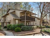 Exterior view of home with two stories, multiple decks, landscaping, and neutral brown color scheme at 1003 Cumberland Se Ct # 1003, Smyrna, GA 30080