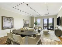 Bright living room featuring modern decor, neutral tones, and sliding glass doors to outdoor patio at 2233 Peachtree Ne Rd # 902, Atlanta, GA 30309