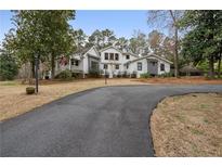 Charming home with a welcoming front porch and long, private driveway nestled among mature trees at 4770 Hilltop Nw Dr, Acworth, GA 30101