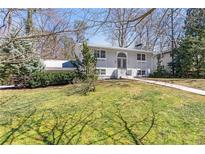 Charming light gray two-story home featuring a well-maintained lawn and a classic architectural style at 2288 Street Deville Ne, Atlanta, GA 30345