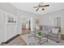 Inviting living room with hardwood floors, a fireplace, and a comfortable sofa at 345 Wellington Sw St, Atlanta, GA 30310