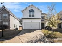 Two-story home with attached garage and long driveway on a sunny day at 5636 One Way, College Park, GA 30349