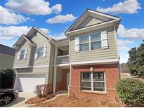 Charming two-story home with light green siding, brick accents, and well-maintained landscaping at 755 Autumn Blfs, Fairburn, GA 30213