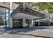 Windsor Over Peachtree entrance with a covered entry and glass facade at 620 Peachtree Ne St # 1613, Atlanta, GA 30308