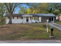 Charming brick home with front yard, painted white with black trim at 1066 Cleavemark Dr, Clarkston, GA 30021