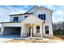 Two-story home with white siding, black shutters, and an attached two-car garage at 660 Redhead Way (Lot 24) Way, Grayson, GA 30017