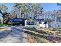 Exterior of home with driveway and attached garage. Well-maintained yard at 2773 Marcia Dr, Lawrenceville, GA 30044