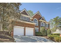 Beautiful brick two-story home with a two-car garage and a well-manicured front yard at 5106 Vinings Estates Se Way, Mableton, GA 30126