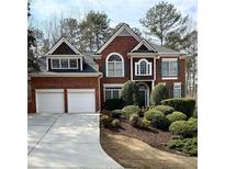 Beautiful two-story brick home with a two-car garage and manicured landscaping in the front yard at 5106 Vinings Estates Se Way, Mableton, GA 30126