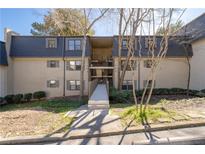 Multi-level condo building featuring neutral siding, dark gray roofing, and direct walkway access to upper floors at 80 Montre Nw Sq, Atlanta, GA 30327