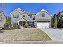 Charming two-story brick home with a well-manicured lawn and a two-car garage at 2515 Castlerock, Cumming, GA 30041