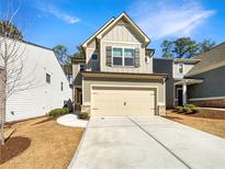 Charming two-story home featuring a two-car garage and well-maintained front yard with a freshly poured concrete drive way at 3671 Salvia Dr, Buford, GA 30519