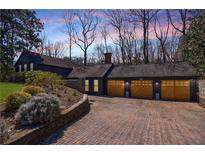 Stunning home exterior with a three-car garage and a beautiful brick driveway at 1110 Vernon Springs Ct, Atlanta, GA 30327