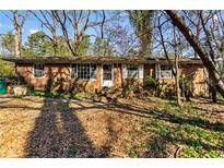 Traditional brick home featuring a front yard covered in leaves surrounded by trees at 3160 Ann Se Rd, Smyrna, GA 30080