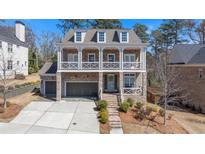 Charming two-story brick home with a welcoming front porch and well-manicured landscaping at 4535 Atley Woods Se Dr, Atlanta, GA 30339