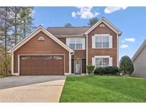 Charming two-story home with brown siding, white trim, and a well-manicured lawn at 848 Gateshead Ct, Lawrenceville, GA 30043