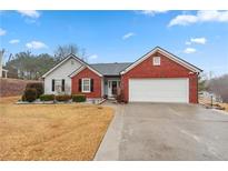 Charming single-story home featuring a brick facade, two-car garage, and well-maintained lawn at 1760 Campbell Ives Dr, Lawrenceville, GA 30045