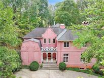 Unique pink exterior home surrounded by mature trees at 4705 Paran Nw Vly, Atlanta, GA 30327
