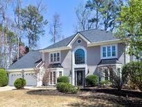 Charming home featuring a two-car garage, well-maintained landscaping, and inviting front entrance at 3304 Woolbridge Ct, Marietta, GA 30062