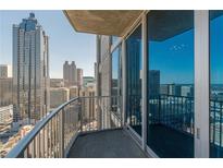 Enjoy the city views from this condo balcony with sliding glass doors and metal railings at 400 W Peachtree Nw St # 3412, Atlanta, GA 30308