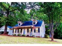 Charming home with a welcoming front porch and mature trees at 410 Invector Ct, Locust Grove, GA 30248