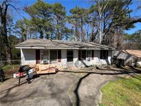 Charming single-story home featuring a paved front yard, a bench, and traditional architectural style at 3382 Phillips Cir, Decatur, GA 30032